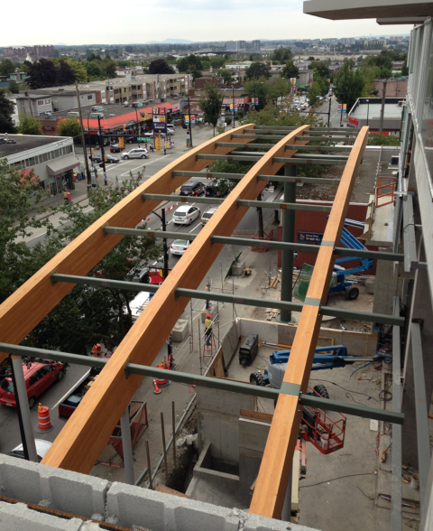 Long timber beams installed on a commercial building under construction