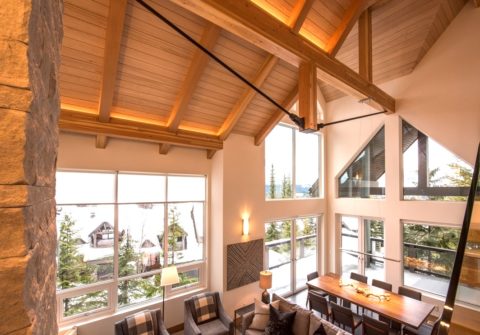 Vaulted living and dining room with timber rafters, steel tension rods and tall windows